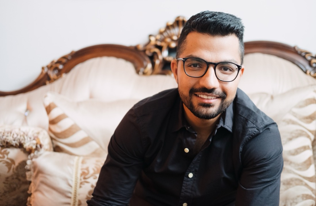 Masood Suliman, Registered Psychotherapist in Ottawa, smiling in a dark shirt and glasses.