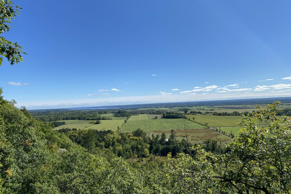 A green valley stretching beneath a clear blue sky.