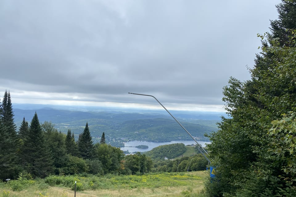 A mountain overlook beneath a broad, cloudy sky.